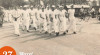 Foto Salah Satu Group Pelajar yang mengikuti Lomba Gerak Jalan sejauh 25 KM melintasi Jalan Raya Kebayoran,  yang diselenggarakan oleh Badan Gerak Jalan Jakarta, 27 Maret 1955.